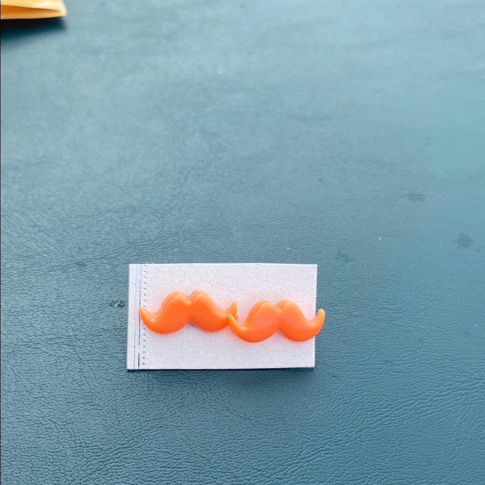 Orange Mustache studded earrings